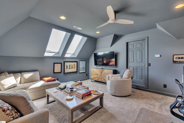 living room featuring lofted ceiling with skylight, baseboards, visible vents, and light colored carpet