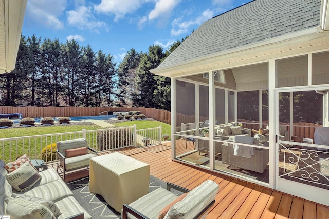 wooden terrace with a sunroom, a fenced backyard, a fenced in pool, and a yard