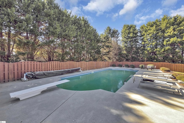 view of pool with a patio area, a fenced backyard, a diving board, and a fenced in pool