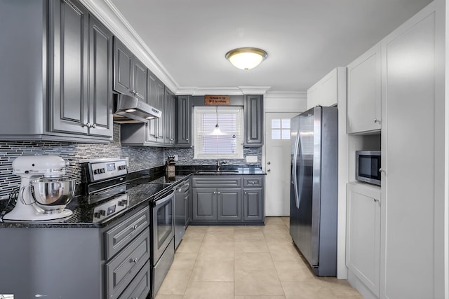 kitchen featuring gray cabinets, appliances with stainless steel finishes, light tile patterned flooring, a sink, and under cabinet range hood