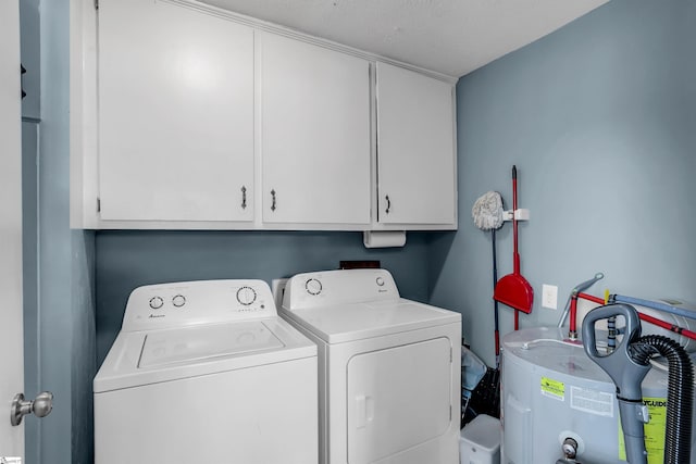 laundry area with water heater, cabinet space, and washer and dryer