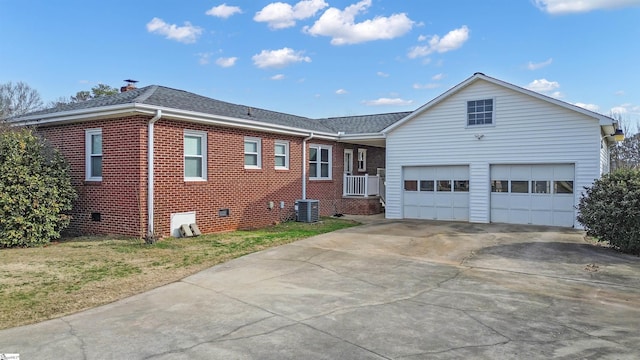 ranch-style house with brick siding, roof with shingles, concrete driveway, crawl space, and a garage