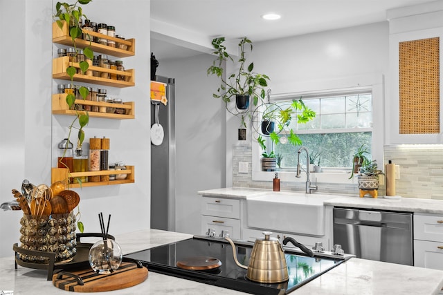 bar featuring black electric stovetop, dishwasher, backsplash, and a sink