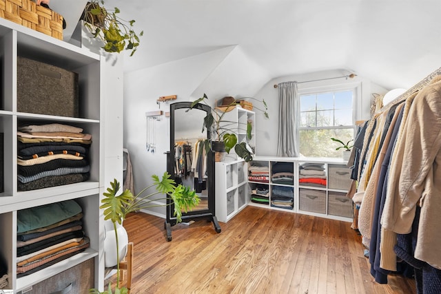 walk in closet featuring lofted ceiling and hardwood / wood-style flooring