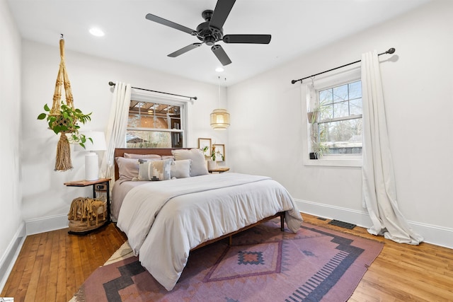 bedroom featuring ceiling fan, baseboards, hardwood / wood-style floors, and recessed lighting