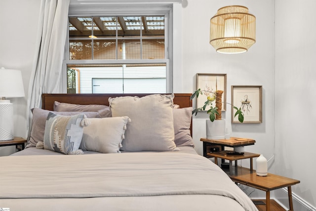 bedroom featuring wood finished floors and baseboards