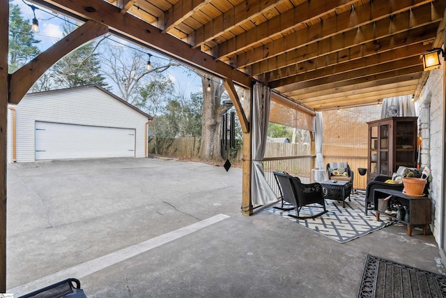 view of patio featuring a fenced backyard, a detached garage, and an outdoor structure