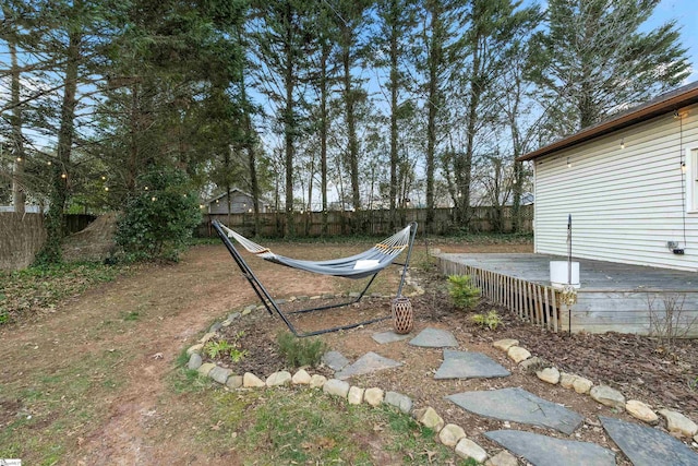 view of yard featuring a fenced backyard and a wooden deck