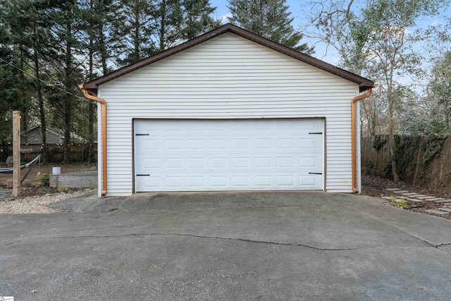 detached garage featuring fence