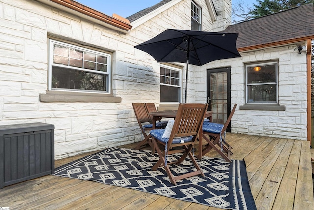 deck with outdoor dining area