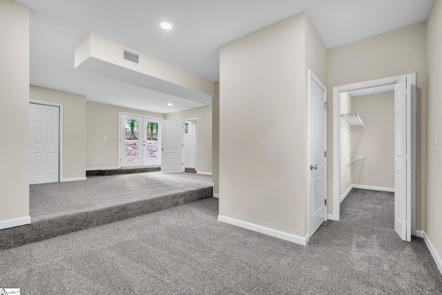 carpeted spare room featuring french doors, recessed lighting, visible vents, and baseboards