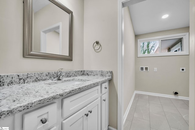 bathroom with vanity, baseboards, and tile patterned floors