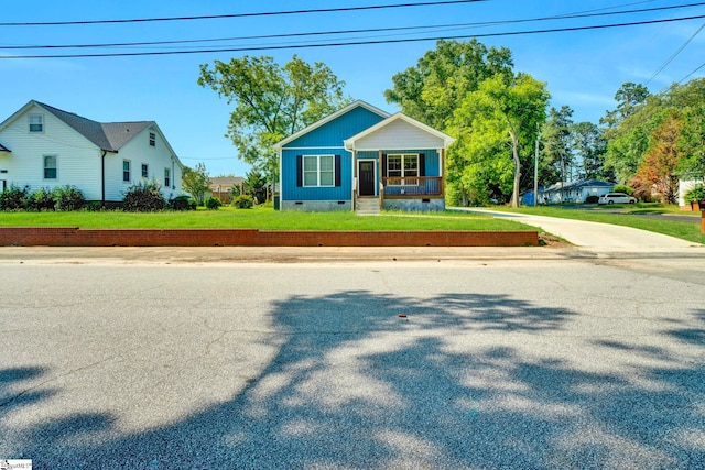 bungalow featuring crawl space, a porch, and a front lawn