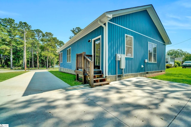 view of front of property with crawl space, a patio, and concrete driveway