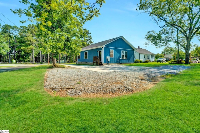 view of front of property featuring concrete driveway, a front lawn, and crawl space