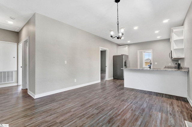 kitchen with open shelves, stainless steel appliances, visible vents, white cabinets, and light stone countertops