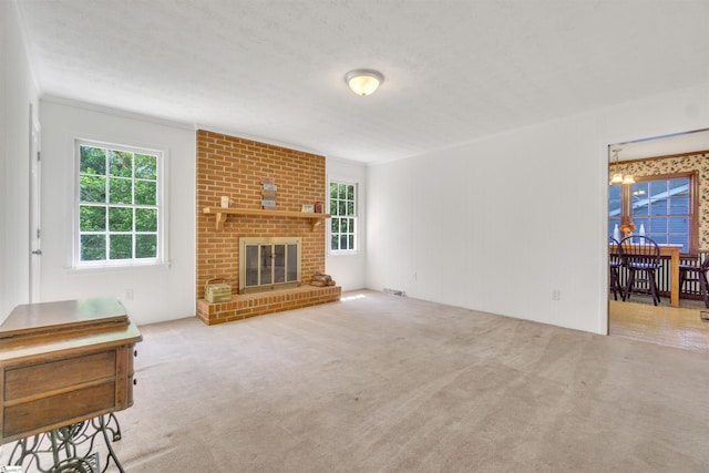 living area featuring visible vents, a brick fireplace, light carpet, and a textured ceiling