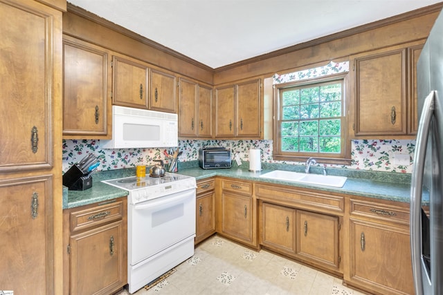 kitchen featuring dark countertops, white appliances, brown cabinets, and a sink