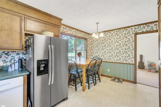 kitchen featuring wallpapered walls, stainless steel fridge, dishwasher, a wainscoted wall, and crown molding