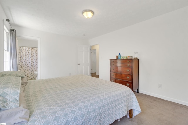 carpeted bedroom featuring baseboards