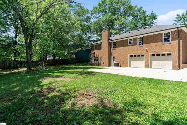 back of property featuring brick siding, a lawn, fence, and central air condition unit