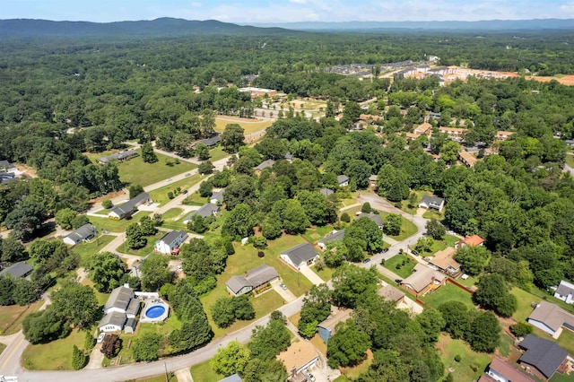 drone / aerial view with a residential view and a wooded view