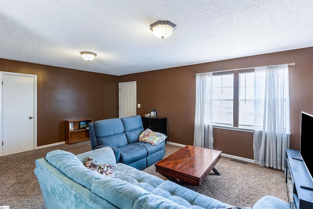 living area with carpet, a textured ceiling, and baseboards