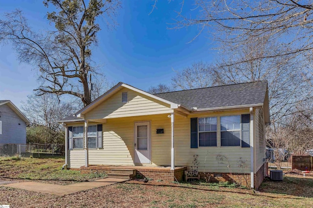 bungalow with crawl space, fence, central AC, and roof with shingles