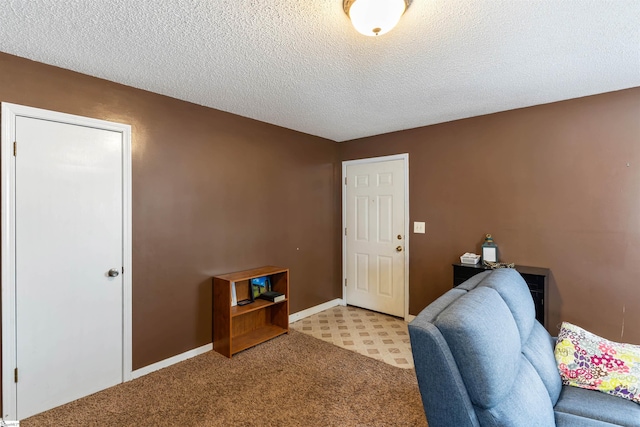 office area with light colored carpet, a textured ceiling, and baseboards