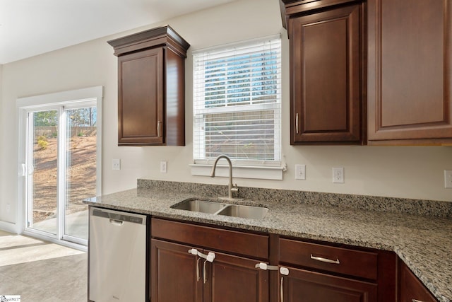 kitchen featuring dishwasher, dark brown cabinets, light stone counters, and a sink