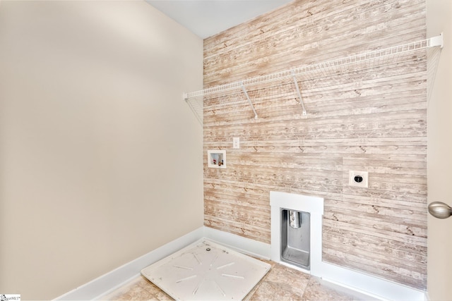 laundry area featuring washer hookup, wood walls, electric dryer hookup, laundry area, and baseboards