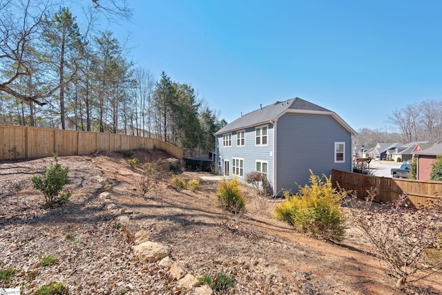 view of side of home featuring a fenced backyard