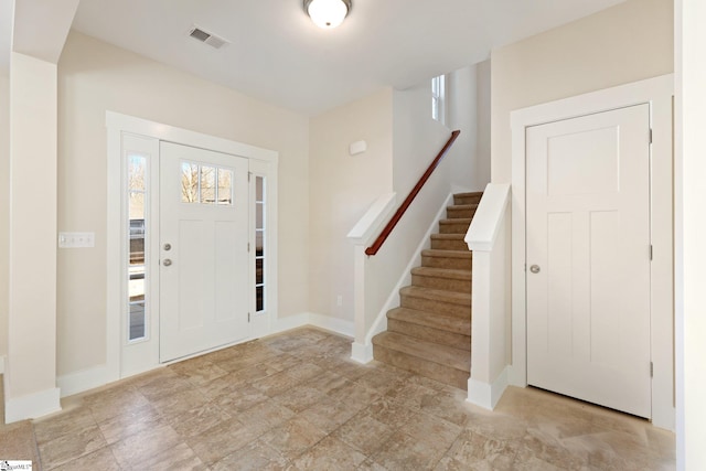 entryway featuring visible vents, baseboards, and stairs