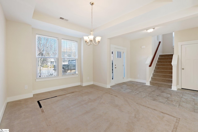 entryway with a tray ceiling, visible vents, stairway, light carpet, and baseboards