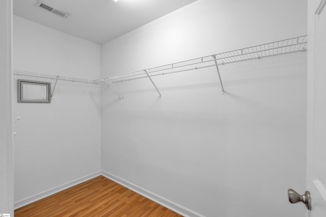 spacious closet with visible vents and wood finished floors