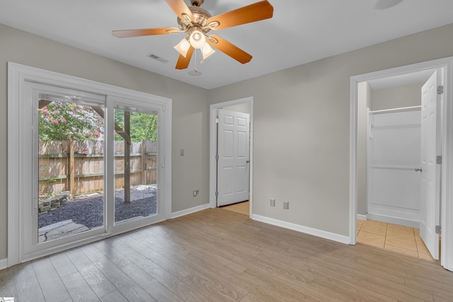 unfurnished bedroom featuring light wood finished floors, baseboards, visible vents, a ceiling fan, and access to exterior