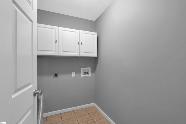 laundry area featuring washer hookup, cabinet space, hookup for an electric dryer, light tile patterned flooring, and baseboards