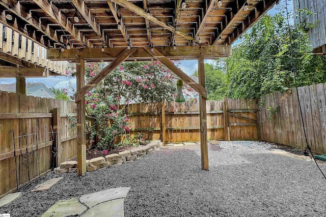 view of yard with a fenced backyard, a gate, and a patio