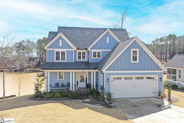 view of front of house with covered porch, a garage, a shingled roof, driveway, and board and batten siding