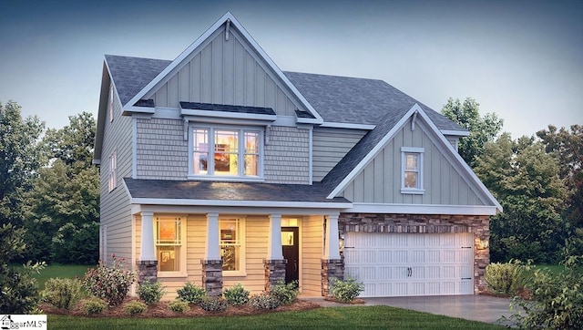 craftsman inspired home featuring a garage, driveway, board and batten siding, and covered porch