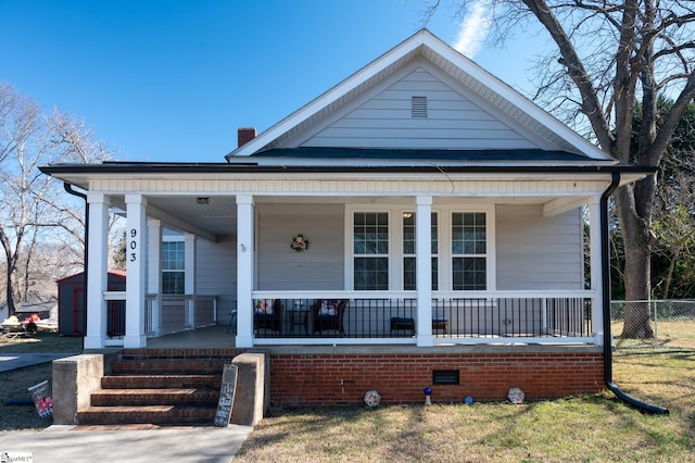 bungalow with covered porch and fence