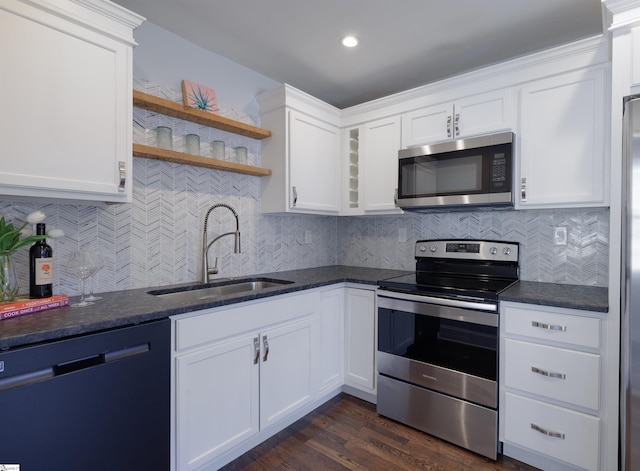 kitchen with a sink, white cabinetry, appliances with stainless steel finishes, decorative backsplash, and open shelves