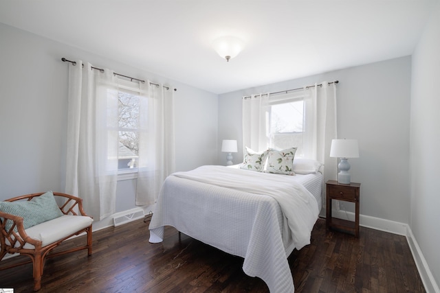 bedroom featuring dark wood-style flooring, visible vents, and baseboards