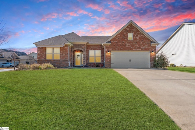 ranch-style home featuring an attached garage, brick siding, a shingled roof, driveway, and a lawn