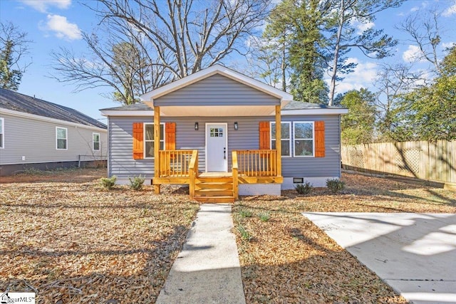 bungalow featuring crawl space, fence, and a porch