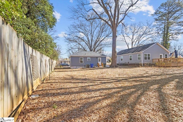 view of yard with fence and a wooden deck