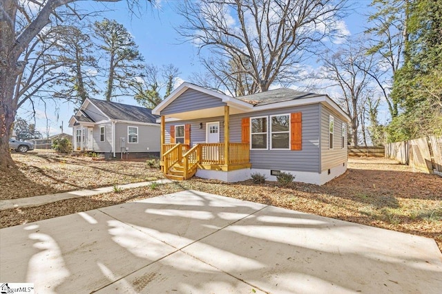 bungalow-style home featuring crawl space and fence