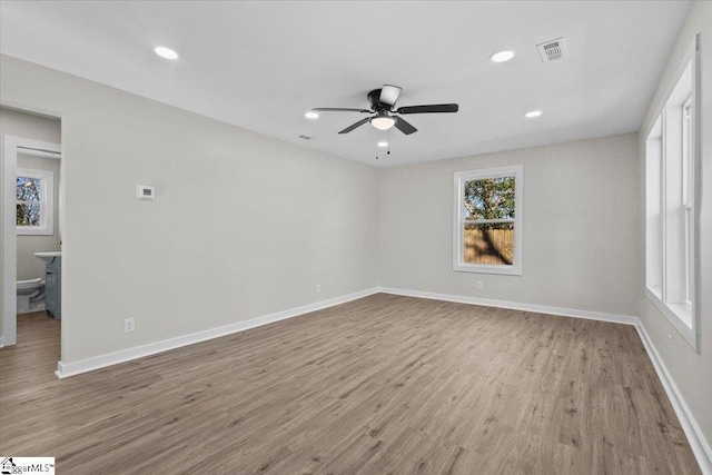 spare room featuring ceiling fan, light wood-style floors, recessed lighting, and baseboards