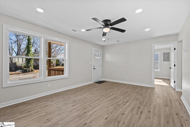 unfurnished living room with light wood-type flooring, recessed lighting, ceiling fan, and baseboards