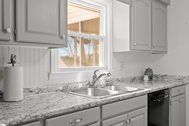 kitchen with light countertops, a sink, and dishwasher